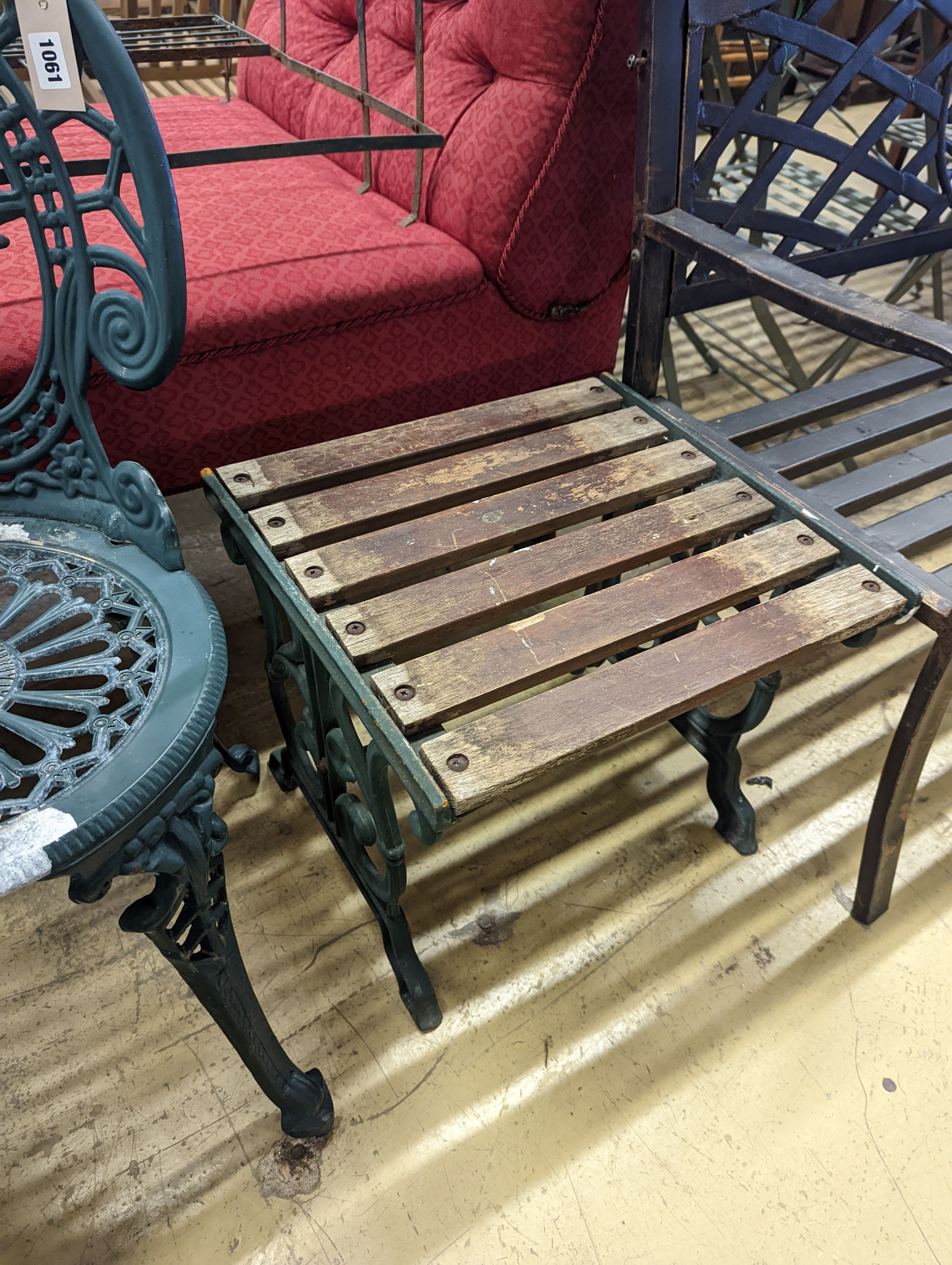 A circular painted aluminium garden table, diameter 60cm, height 62cm together with two chairs